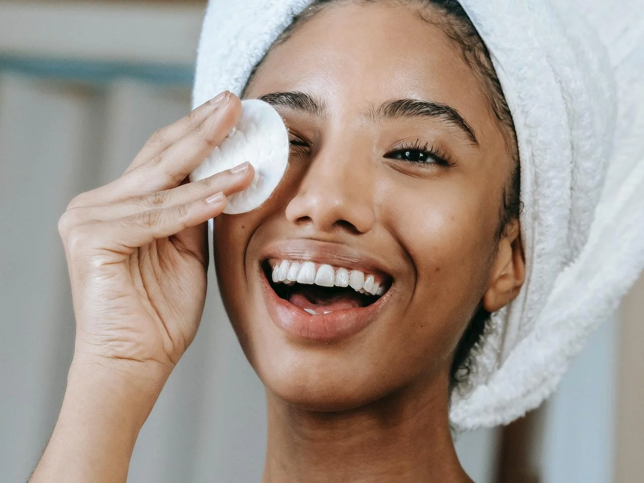 Woman applying skincare cream as part of her beauty routine